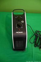 Front view of NOMA heater showing control panel with two rotary dials and power indicator light.