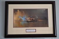 Framed Spitfire print hanging against wall showing entire piece.