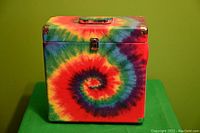 Front view of the tie dye patterned vinyl record carrier showing the circular spiral design and metal clasp.