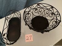 Photo of the two metal baskets, round centerpiece bowl and rectangular bread basket with scroll and leaf metalwork.