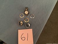 Overhead view of wrist watch with white face surrounded by four interchangeable decorative borders.