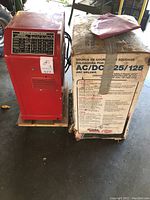 Welder and original packaging box side view on wooden board