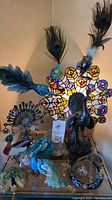 Full view of lamp, figurines, horseshoe, patch, pendant, bookmark, dish and earring holder with earrings