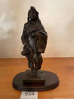 Front view of bronze sculpture on wood base