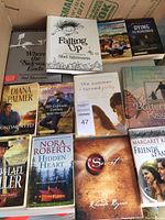 Top view of all 12 books showing cover titles and authors including Shel Silverstein, Diana Palmer, Bob Carlisle, Nora Roberts, Rhonda Byrne, and others.