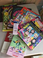 Photo of colorful kids' books and puzzles stacked showing titles and covers