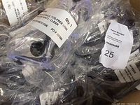 Clear view of individually sealed goggles with labels stating 'Economy Goggles Fog-Free Lens Clear','Qty 1'. Shows multiple goggles in packaging.