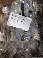 Multiple economy brand goggles individually wrapped in plastic in a box, showing quantity and packaging condition.