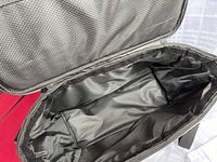 Interior view of black duffle bag showing soft fabric lining
