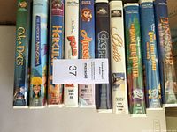 Photo of VHS tapes lined up showing spines and cases for identification