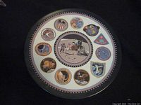 Full view of the plate showing the central lunar landing image and surrounding Apollo mission crests.