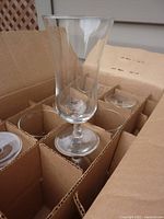 Box containing 8 parfait glasses, one glass removed and placed upright showing shape and size.