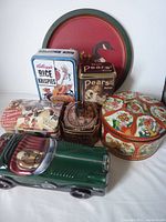 Overview of all decorative tins and car tin showing various vintage and floral designs
