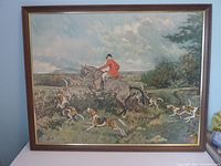 Framed hunting scene picture showing whole framed artwork with rider, horse, and hunting dogs.