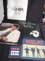 Photo showing four vinyl LP albums: Michael Jackson, Requiem by Andrew Lloyd Webber, The Phantom of the Opera, and two Beatles HELP! souvenirs.