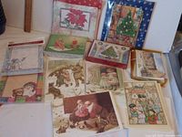 Overview of multiple vintage unused Christmas and winter-themed cards laid out on a flat surface.
