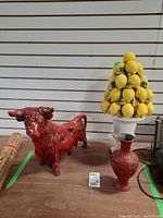 Overview of the set showing the red bull figurine, lemon topiary vase, and red cinnabar vase