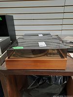 Front angle photo of the Dual 505 turntable showing wooden base and clear dust cover.