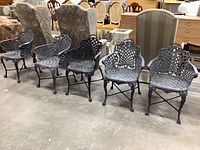 Front view of five cast aluminum chairs lined up