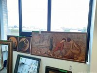 Wide shot showing all three framed original portraits leaning against a window. Two smaller oval portraits and one large horizontal rectangular portrait.