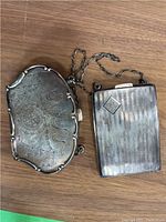 Top view of both closed cases showing exterior patterns and tarnish