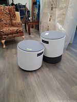 Two cylindrical stools side by side on floor