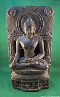 Front view of Buddha statue showing seated Buddha with detailed backdrop and lotus base.