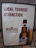Front view of Canadian beer advertisement light showing the promotional text and Molson Canadian beer bottle image.