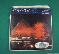 Photo of the Expo 67 View-Master slide pack featuring an illuminated structure at night on the cover and text indicating 21 stereo photos.