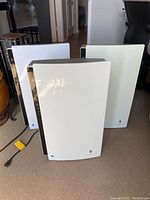 Front view of three white Friedrich air purifier units side by side