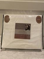 Full packaged sheet set in clear plastic wrapping showing Kathy Ireland Essentials label and product details.