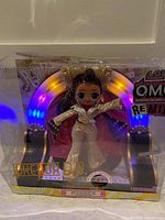 Front view of LOL Surprise O.M.G. Remix Jukebox D.B. doll in original packaging showing doll, outfit, and backdrop.