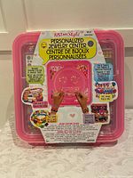 Image of the Just My Style Personalized Jewelry Center package showing the closed pink case with colorful beads and text descriptions on the box.