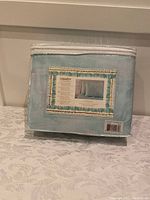 Photo of the packaged blue queen size sheet set with brand label visible.