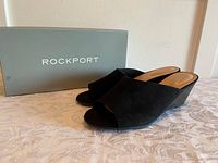 Black suede Rockport women's sandals placed on box showing both side and front angles