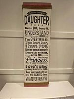 Front view of the wooden wall hanging with printed text.