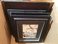 Four framed prints stacked together showing size and frame style, dark brown/black frames with black mats