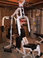 Full view of Parabody 350 home gym showing seated press arms, weight stack, and padded seat in basement setting