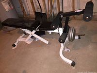 Full view of the Parabody adjustable weight bench with attached leg extension/curl component placed on floor in basement setting.