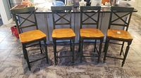 Four chairs arranged in front of kitchen island showing entire set
