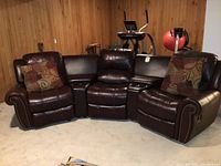 Three-piece sectional setup showing left recliner, center console, right recliner and throw pillows