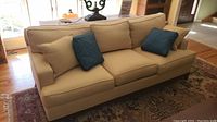 Front view of sofa showing removable cushions and two accent throw pillows