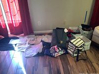 Wide shot of all items showing dust covers folded on the floor, a few dog sweaters, canvas baskets, and insulated tote