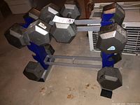 Front angle of rack loaded with six hex dumbbells