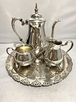 Full set including tea/coffee server, creamer, sugar bowl on the ornate tray, showing overall condition and design.