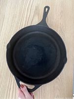 Top down view of large cast iron pan showing interiors and handles
