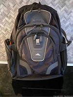 Front view of large black High Sierra backpack showing multiple compartments and logo