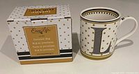 Photo of the Easy Life L Monogram porcelain mug next to its original box showing the mug's design and packaging
