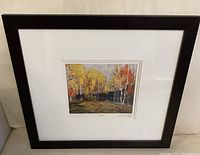 Framed print showing landscape with birch trees, fall colors, and textured brushwork.