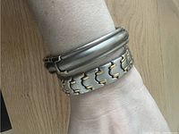 Bracelets worn on wrist showing style and size comparison.